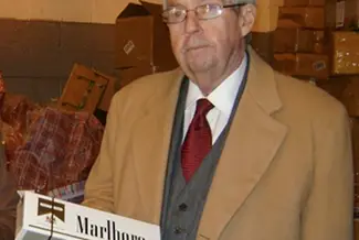 Brooklyn DA Charles Hynes looking kinda bummed out with a carton of fake Marlboros.